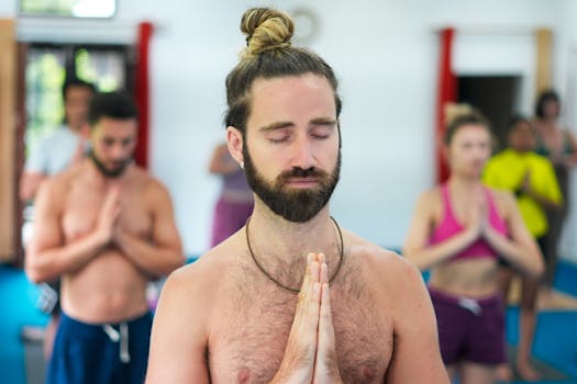 A diverse group of individuals meditating during a yoga class, focusing on mindfulness.