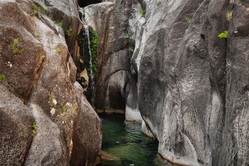 Free Serene waterfall in rocky landscape at Cascata do Arado, Vilar da Veiga, Portugal. Stock Photo