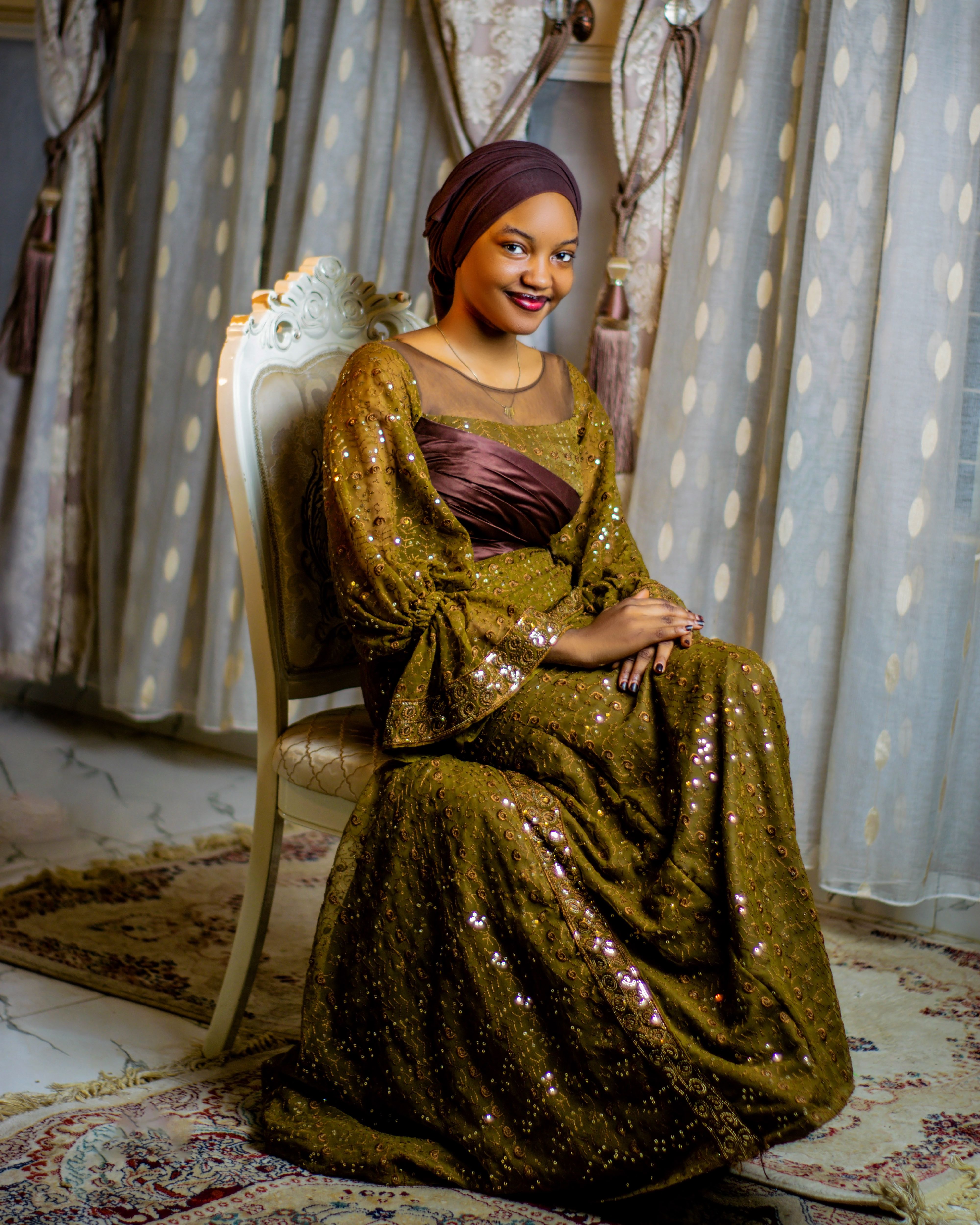 Elegant Woman in Traditional Attire Seated Indoors · Free Stock Photo