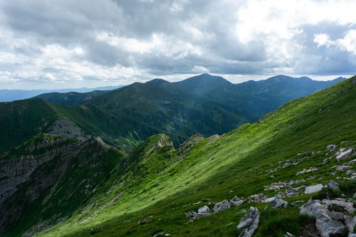 Free Scenic view of a lush mountain range under dramatic cloudy skies. Stock Photo