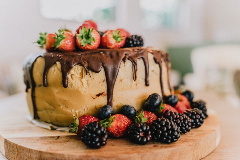 Rustic berry celebration cake finished with fresh fruit