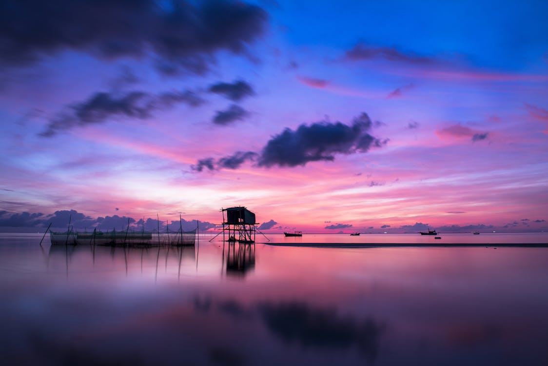 Body of Water Under Blue Sky during Golden Hour