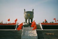 Ancient Chinese Monument with National Flags