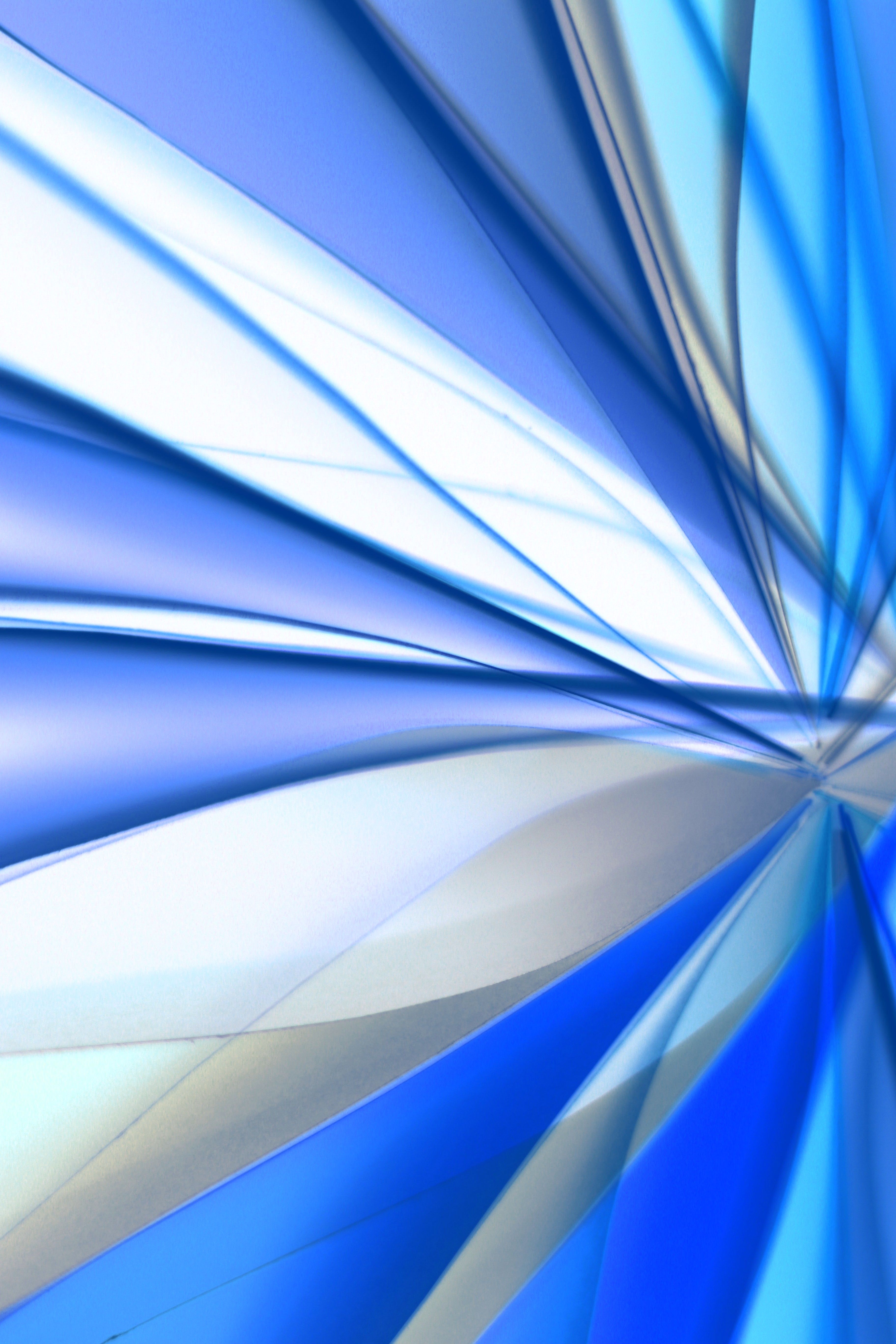 Dynamic abstract image featuring blue and white geometric shapes with a modern style.