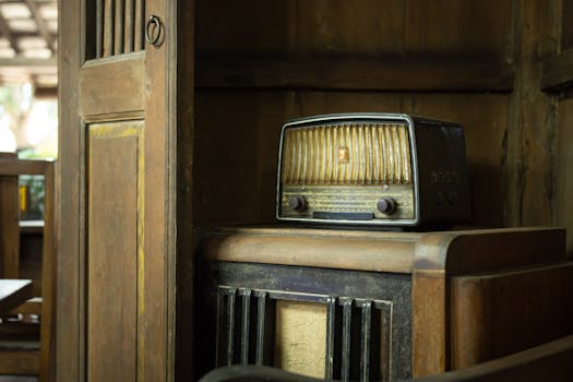 A classic vintage radio set on a wooden shelf, showcasing retro aesthetics and antique appeal.