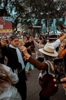 Adults dancing at a vibrant street festival in Buenos Aires, showcasing cultural heritage.