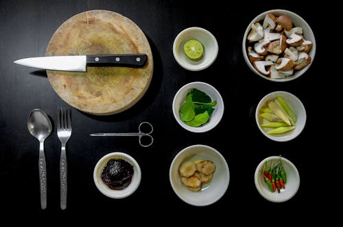 Spices on Bowl Near Knife on Chopping Boad