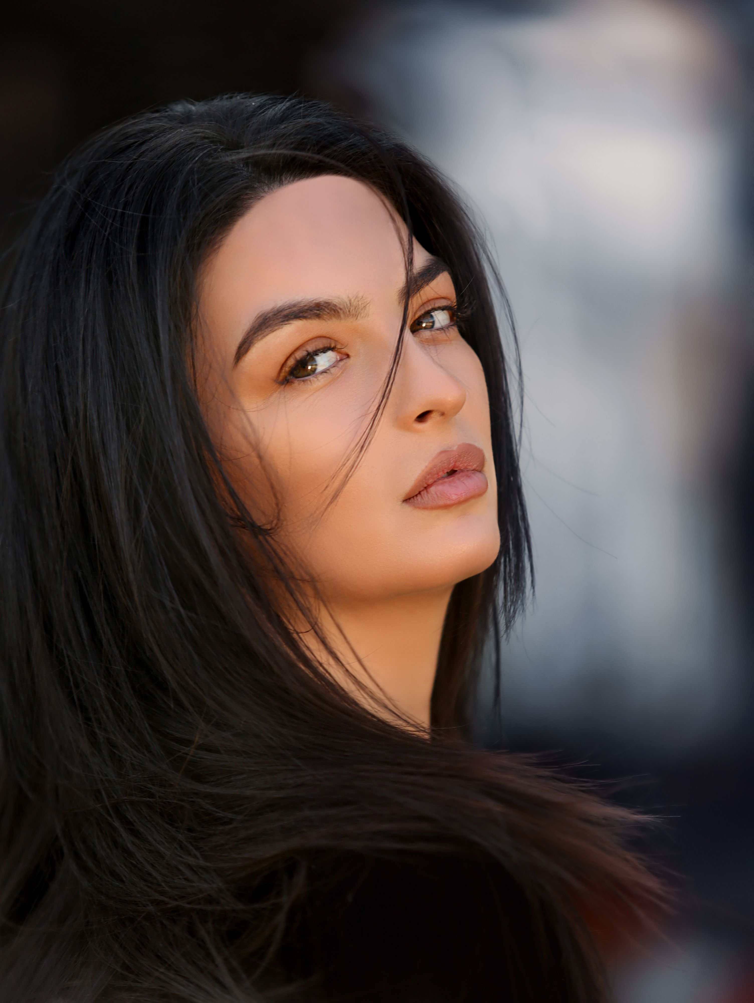 A captivating portrait of a woman with flowing dark hair and a natural expression. Perfect for beauty and fashion concepts.