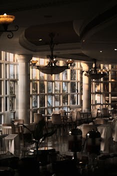 Luxury dining room in upscale resort with chandeliers and morning sunlight, Dar es Salaam, Tanzania.