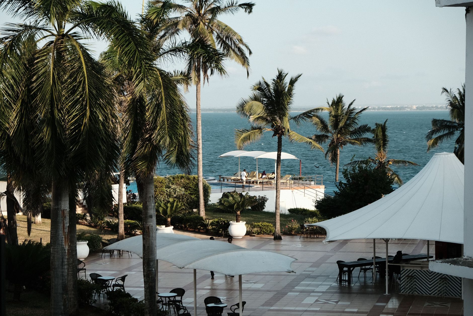 Tropical paradise with ocean views and palm trees at a luxury resort in Dar es Salaam, Tanzania. Related image for Hospitality in Africa: What Hotel Leaders Need to Know.