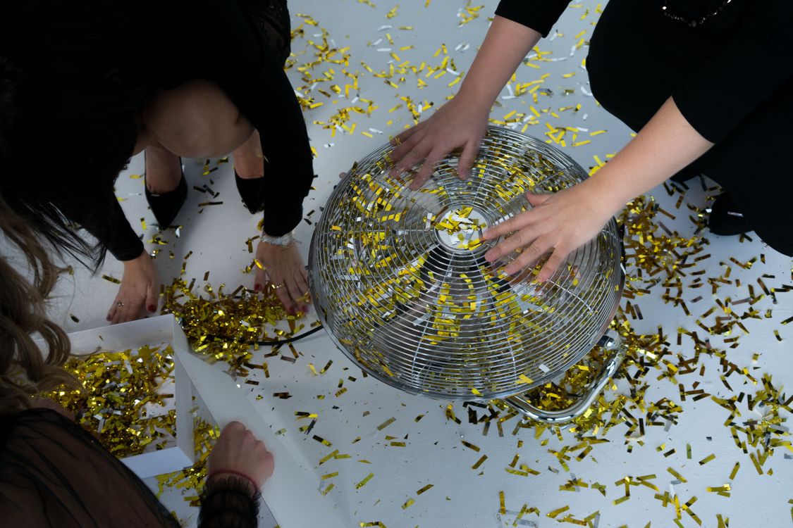 Person Holding An Electric Fan With Confetti · Free Stock Photo