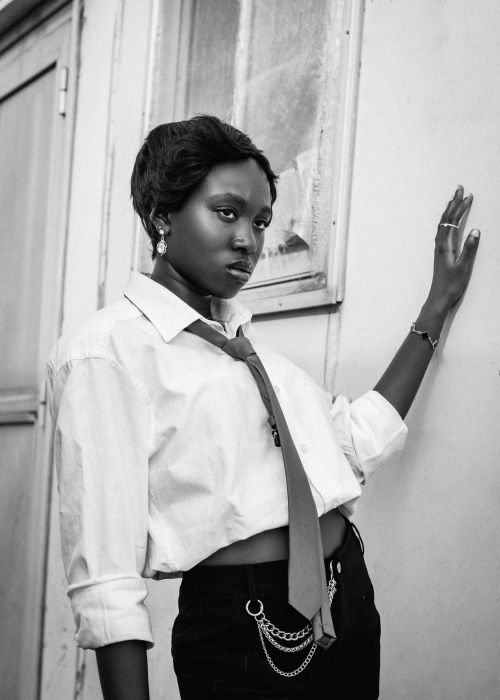 Free Elegant black and white portrait of a woman in a tie posing confidently. Stock Photo