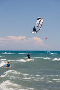 Exciting kitesurfing scene at Ulcinj beach, Montenegro under clear skies.