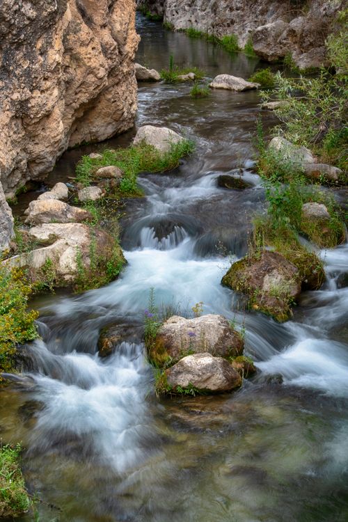 Free Peaceful creek with rocks and foliage in Castril, Andalucía, Spain. Perfect for nature themes. Stock Photo