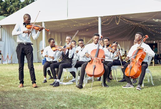 African ensemble performing classical music outdoors with violins and cellos.