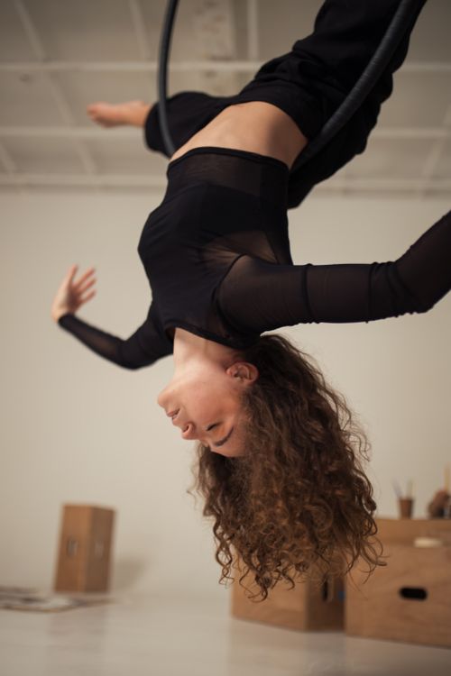 Free Aerial artist performing gracefully on hoop indoors, showcasing elegant movement. Stock Photo