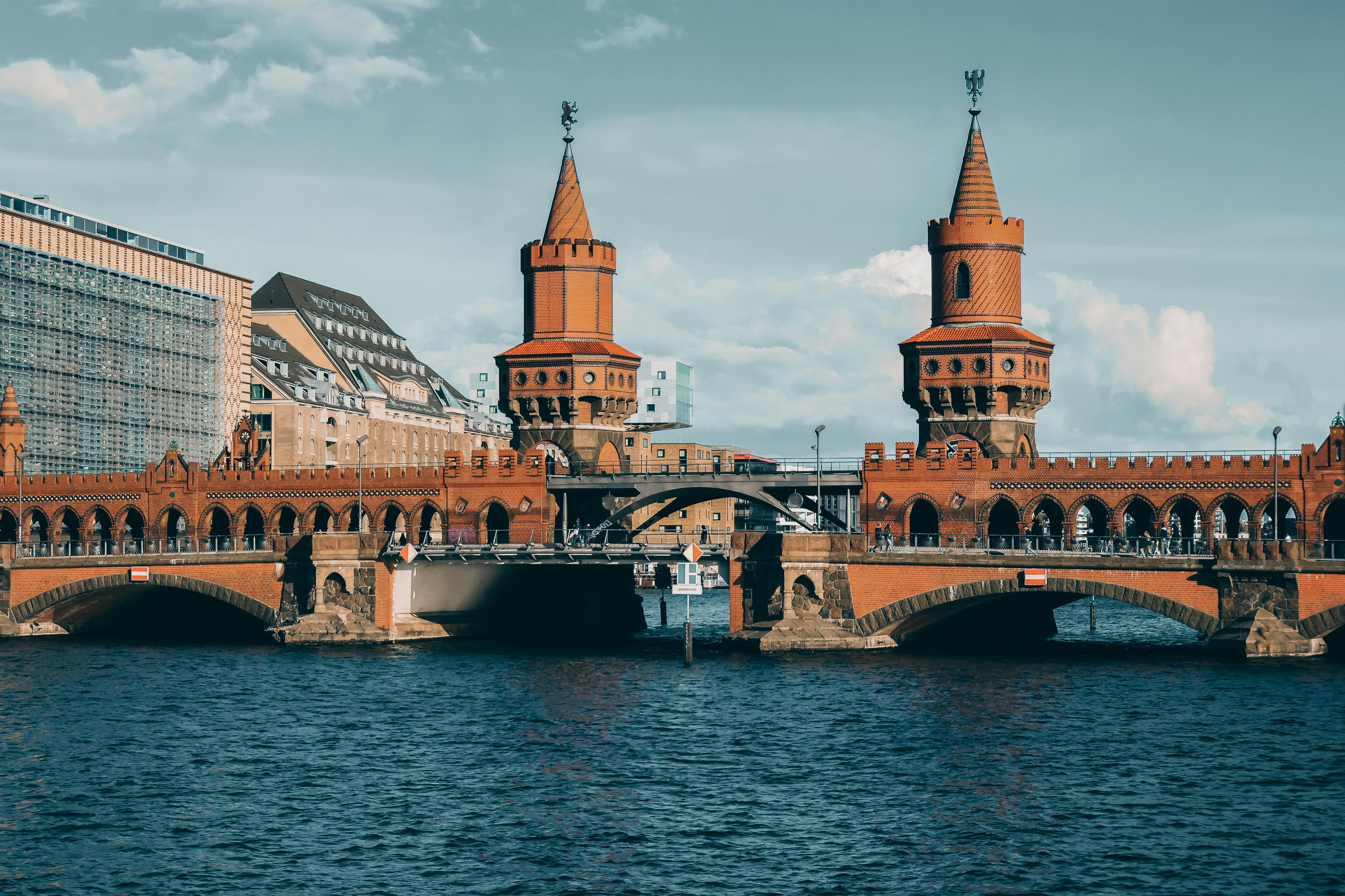 Iconic Oberbaum Bridge spanning the Spree River in Berlin, showcasing its Gothic Revival architecture.
