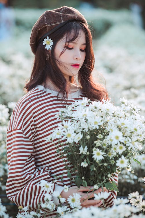 Woman Holding White Flowers · Free Stock Photo
