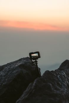 A camera on a rocky cliff captures a stunning sunset view in Ciudad de México, Mexico.