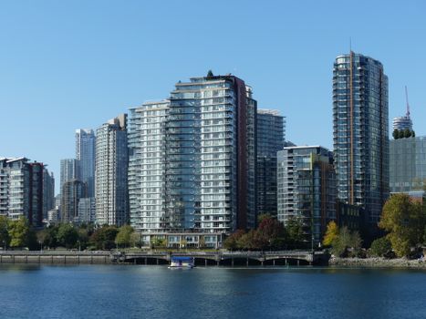 The stunning modern skyline of Vancouver, BC, featuring high-rise buildings along the waterfront on a clear day.