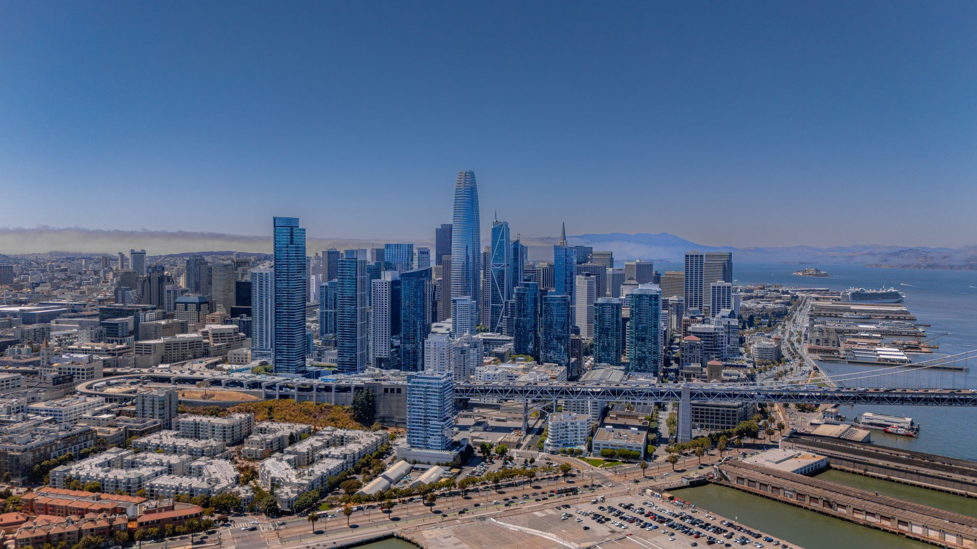 San Francisco skyline featuring Salesforce Tower and the Bay Bridge, with the Transit Center area visible in the foreground