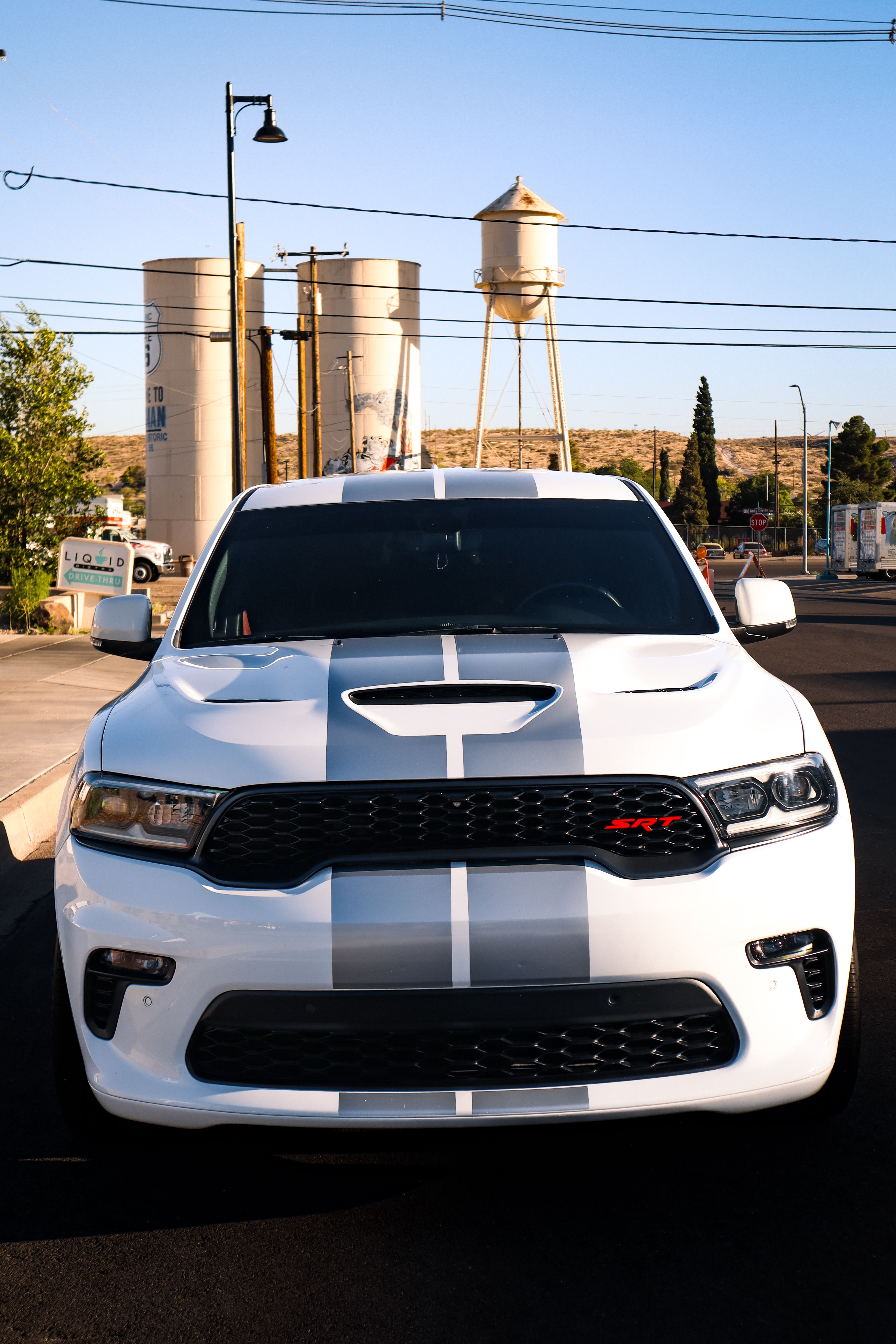 White SUV with Racing Stripes in Urban Area · Free Stock Photo