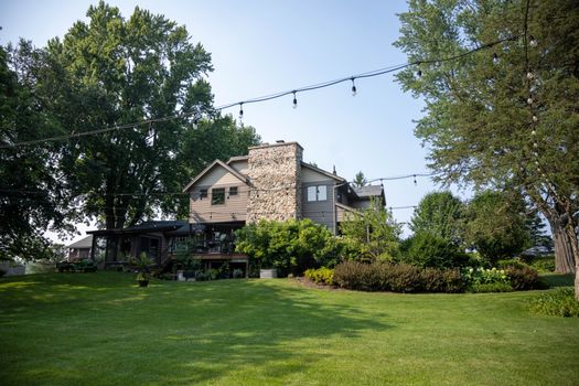 Beautiful countryside home in Oconomowoc, Wisconsin, surrounded by lush greenery.