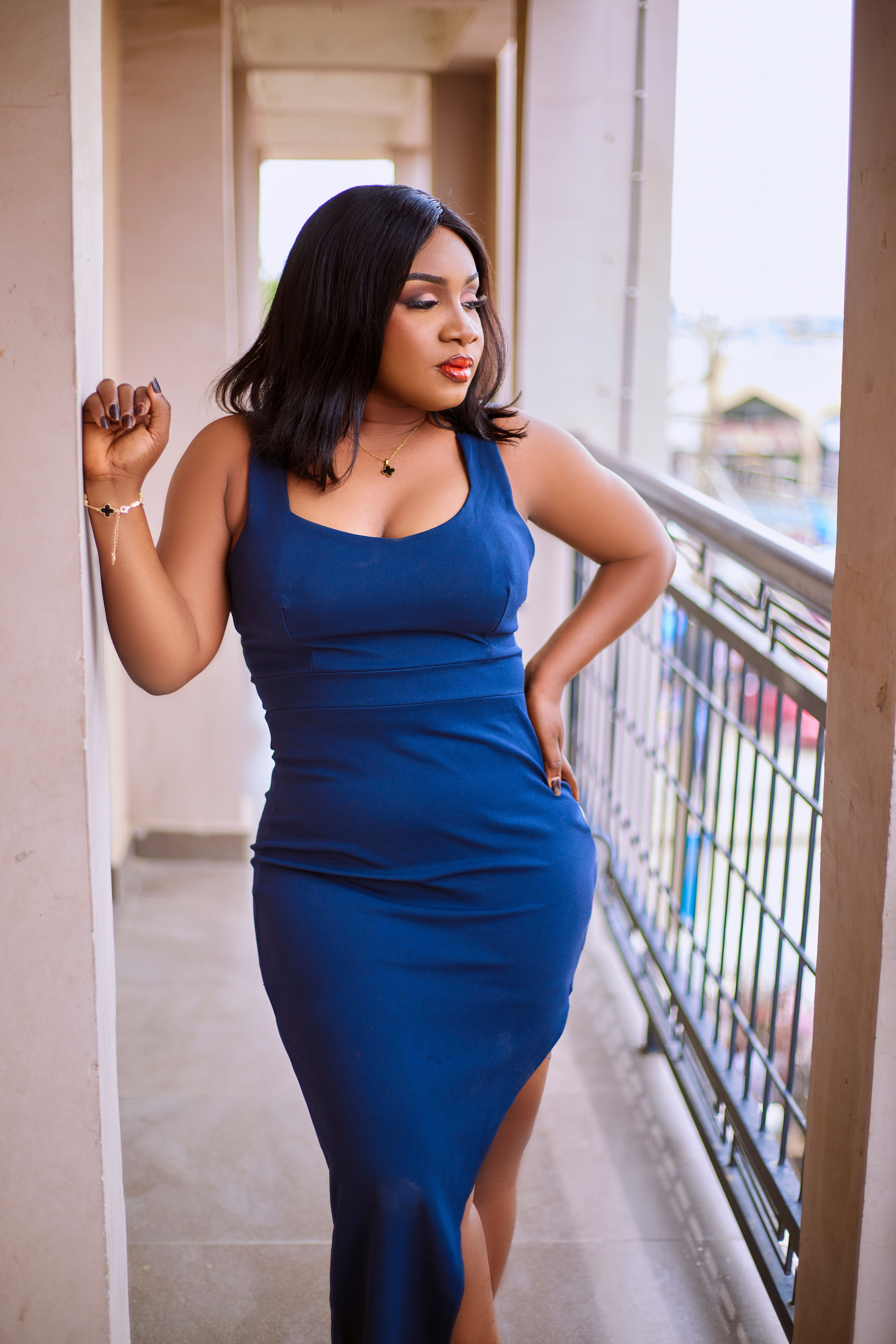 Elegant Woman in Blue Dress on Balcony · Free Stock Photo