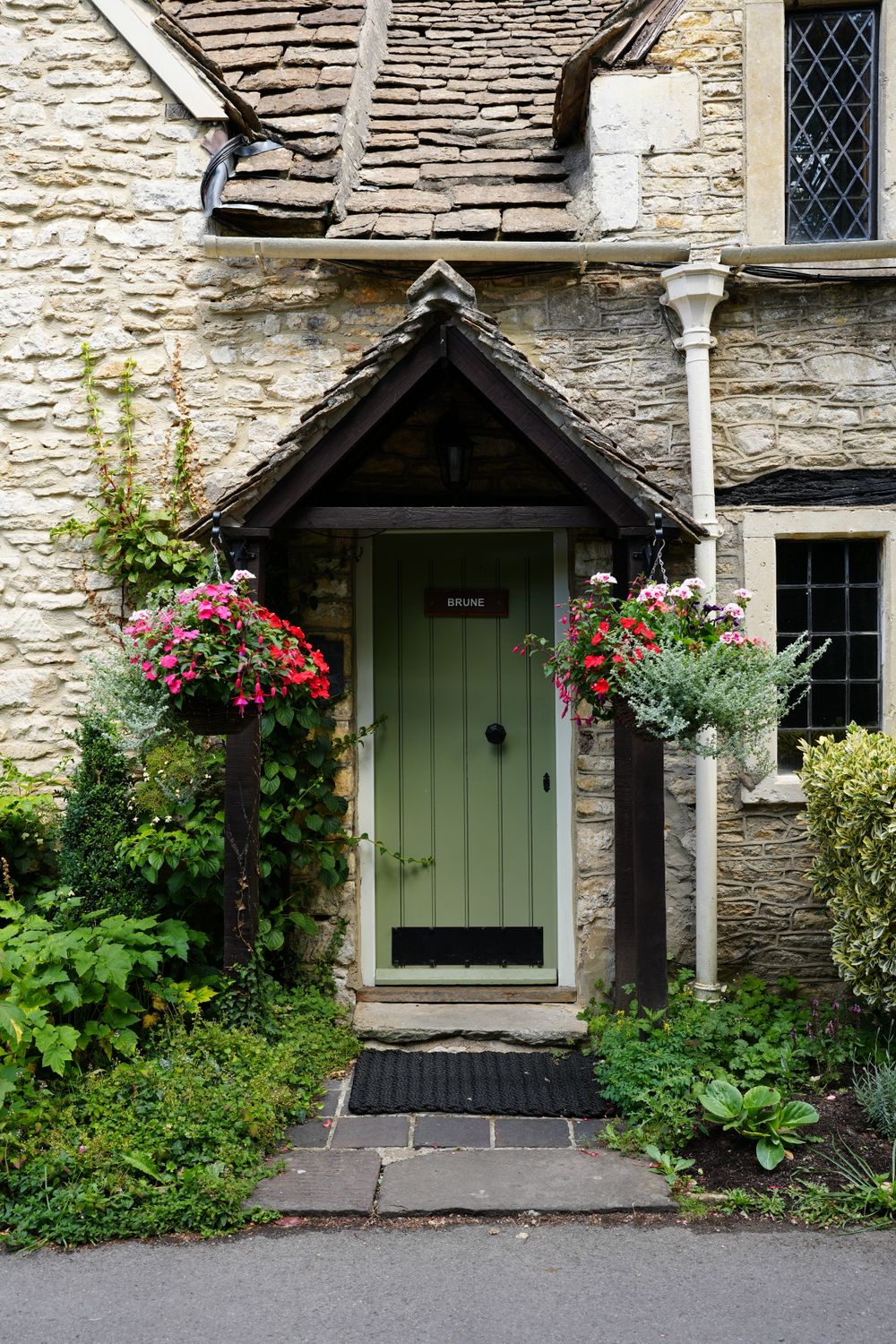 Charming English Stone Cottage Entrance with Flowers · Free Stock Photo