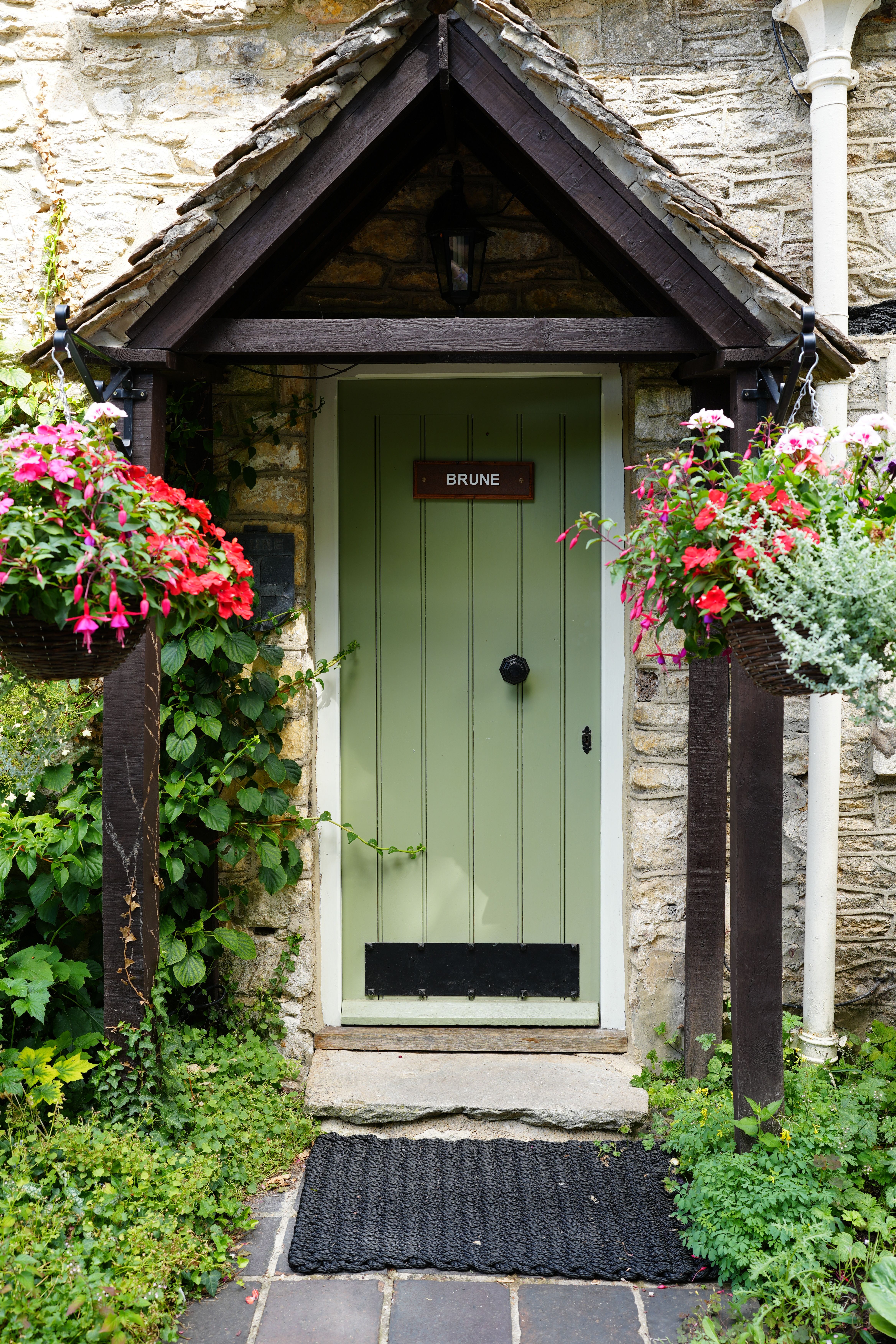 Charming English Stone Cottage Entrance with Flowers · Free Stock Photo
