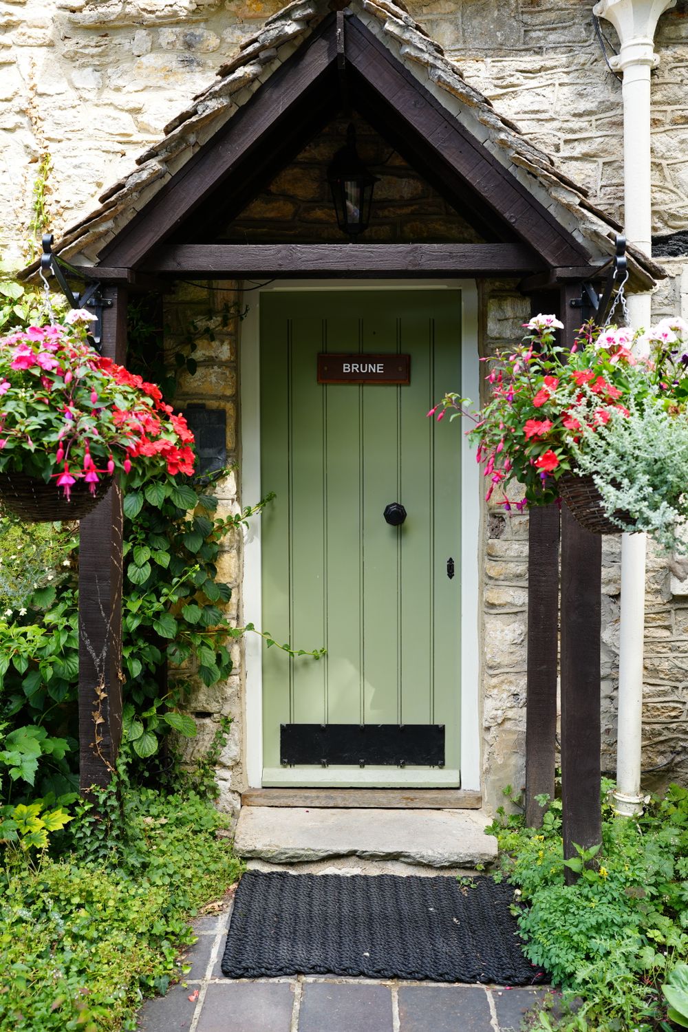 Charming English Stone Cottage Entrance with Flowers · Free Stock Photo