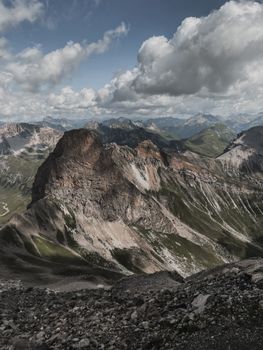 Experience the breathtaking beauty of alpine mountains under a dramatic sky.