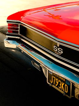 Vintage Chevrolet SS 427 in striking red with California license plate at sunset.