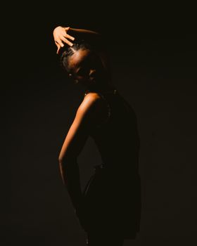 A striking silhouette of a dancer posing gracefully against a dark backdrop.