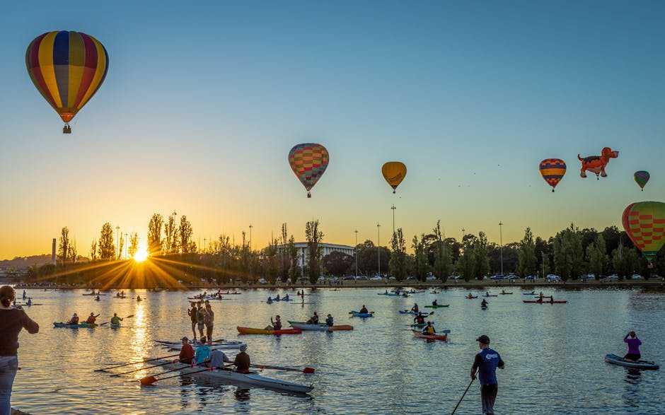 Colorful hot air balloons and kayaks on Lake Burley Griffin at sunrise, Canberra.