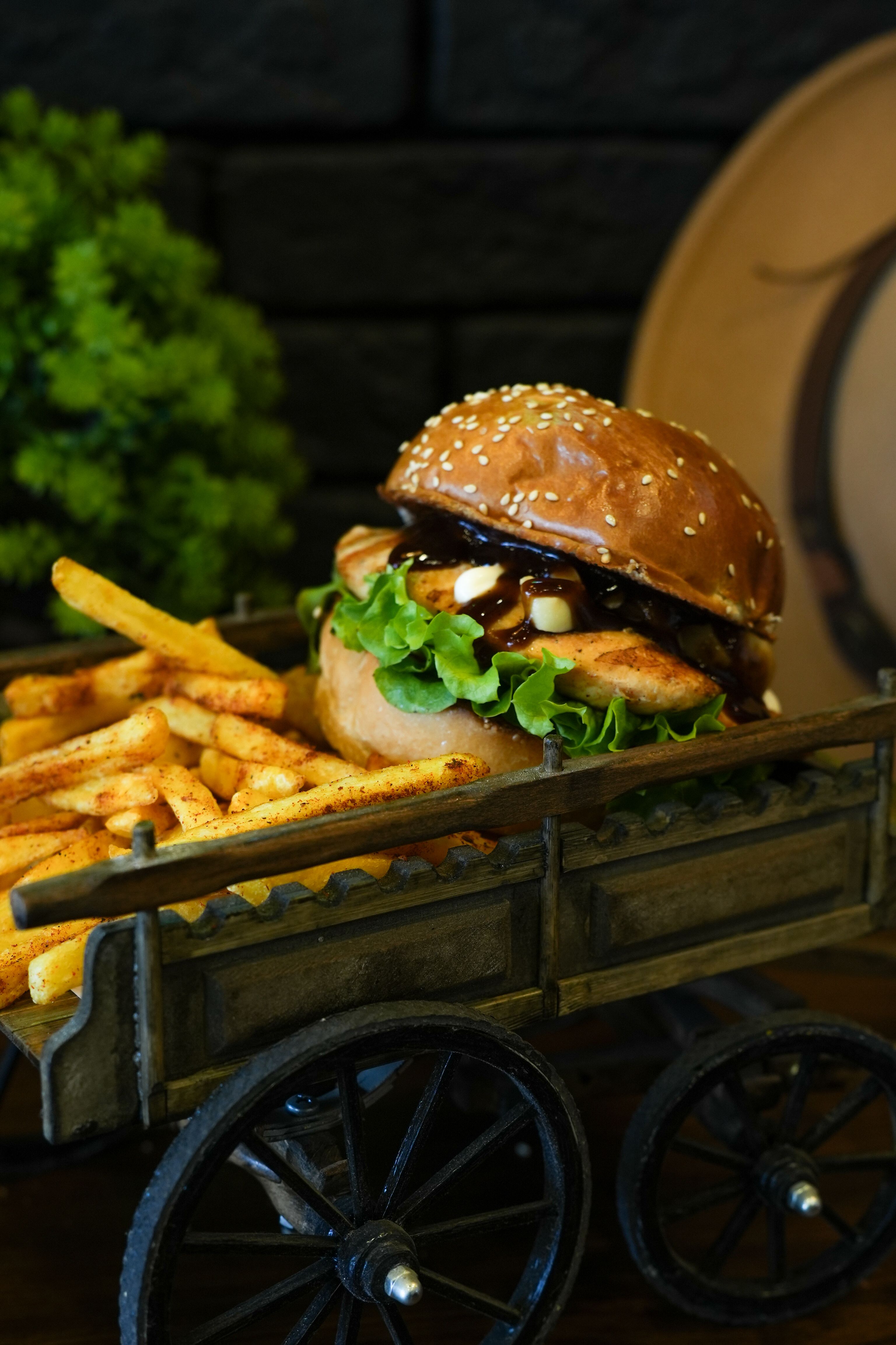 Gourmet Burger with Fries on Rustic Cart · Free Stock Photo