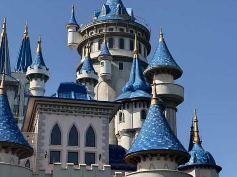 A beautifully detailed shot of a fairytale castle with blue turrets and gothic architecture.