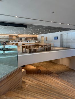 Spacious modern cafe with wooden interiors, showcasing minimalist design and bright atmosphere.