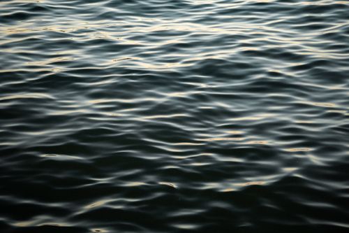Free Serene image of rippling water at dusk, capturing gentle waves and reflections. Stock Photo