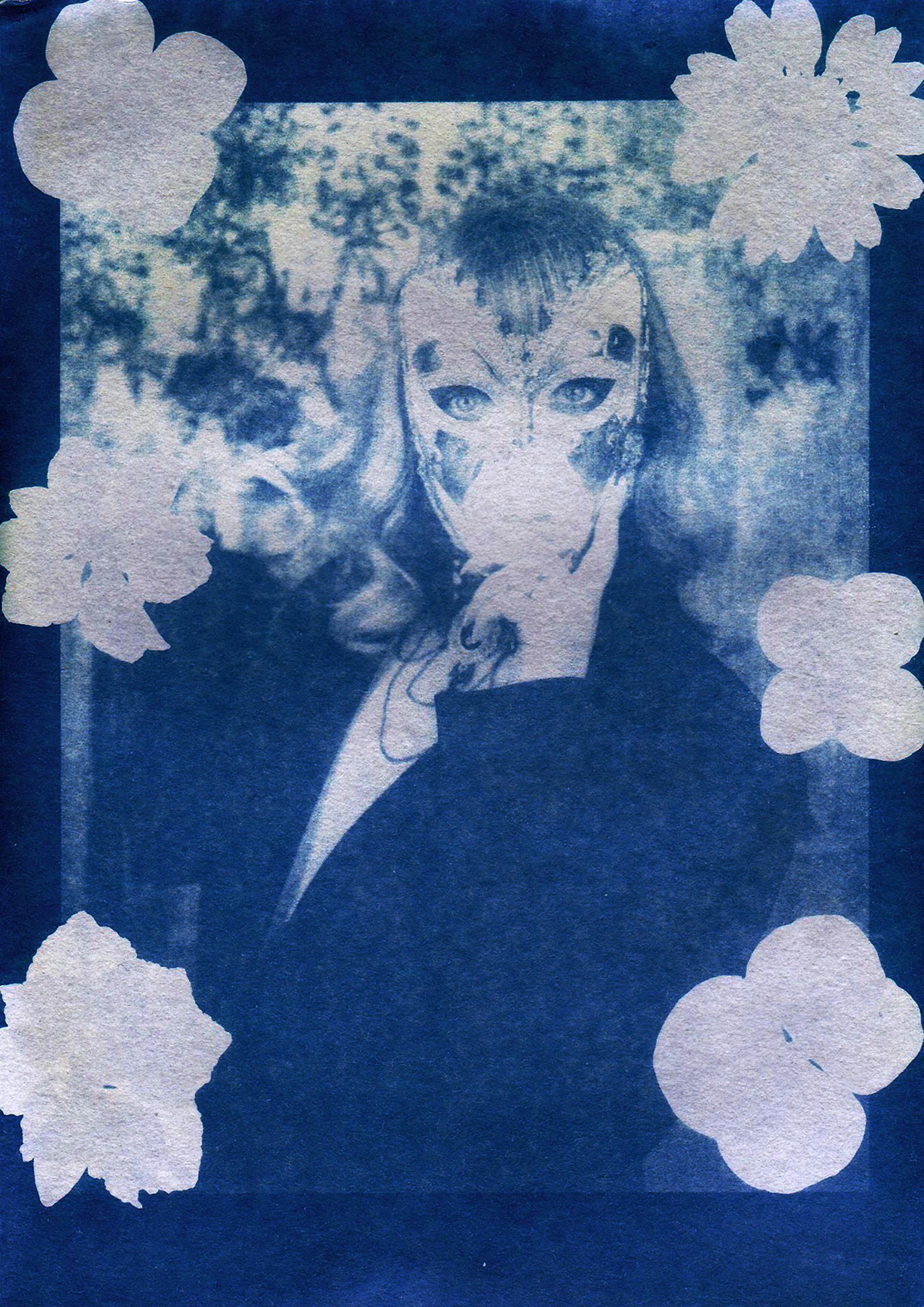 A surreal cyanotype print of a masked figure surrounded by floral accents, evoking mystery.