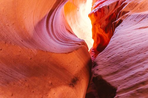 Free A stunning view of Antelope Canyon's vibrant sandstone curves illuminated by natural sunlight. Stock Photo