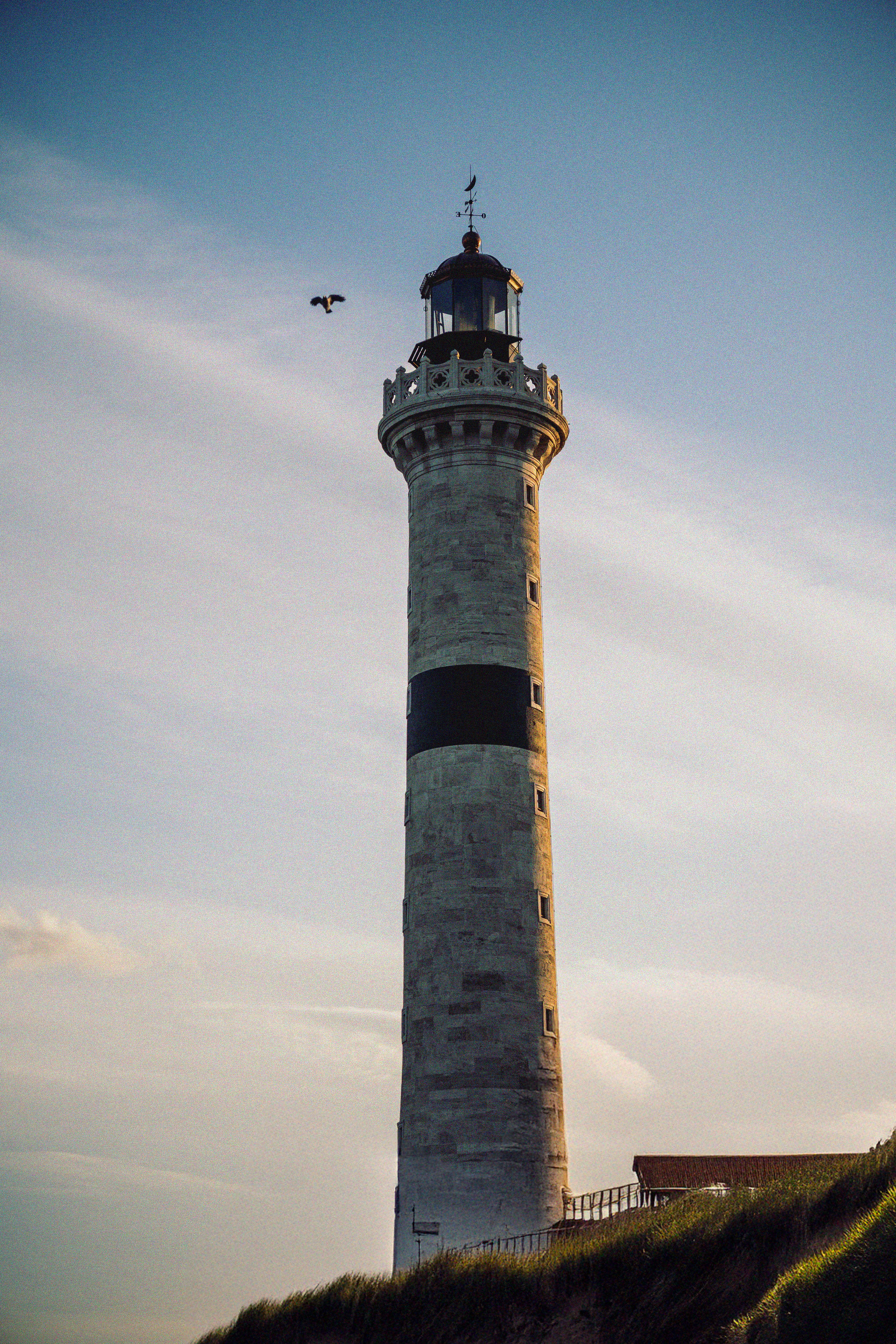 Majestic Lighthouse Against Blue Sky