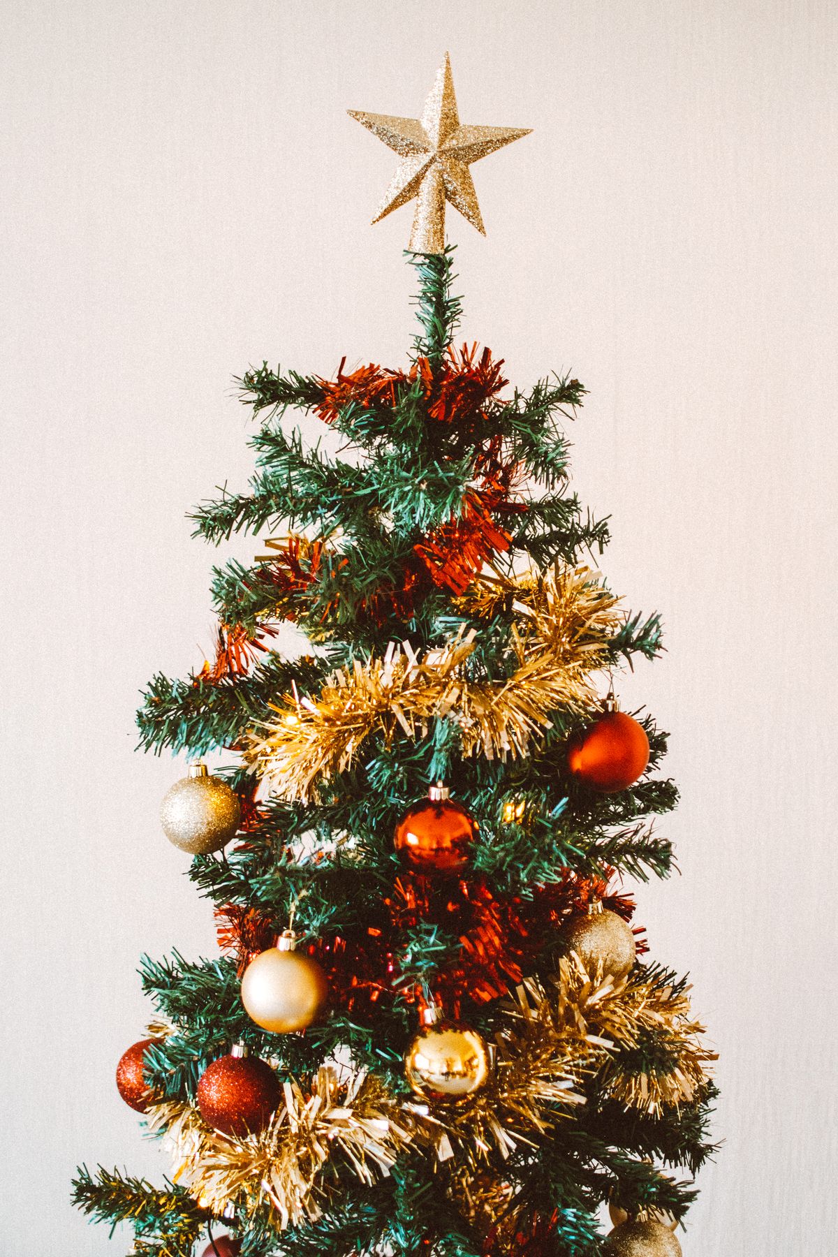Classic Christmas tree with red and gold ornaments and a star topper