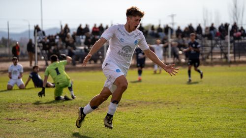 Free Teenage soccer player celebrates a goal during an intense outdoor match. Stock Photo