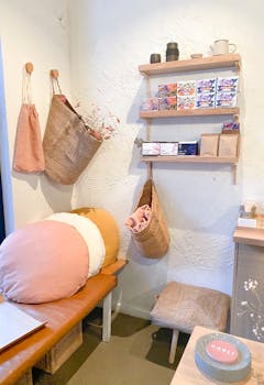 A cozy corner featuring rustic decor with baskets, pillows, and shelves in a Melbourne shop.