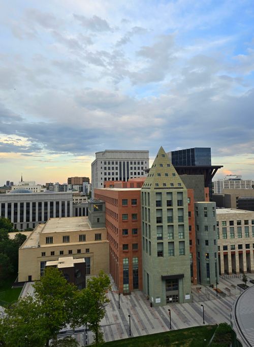 Free Skyline of a downtown area with modern architectural buildings under a cloudy sky. Stock Photo