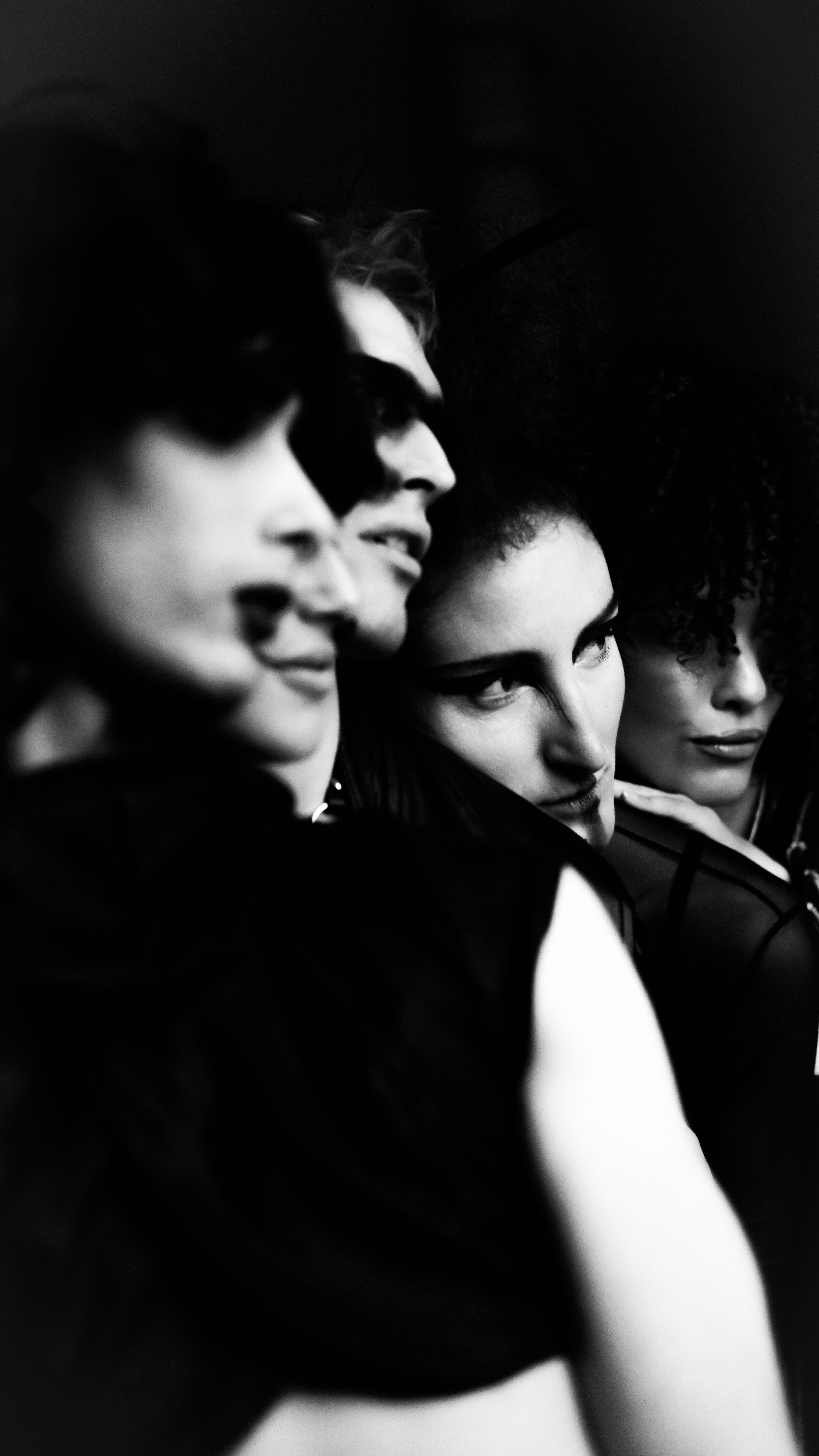 Dramatic black and white portrait of a diverse group reflecting fashion and identity.