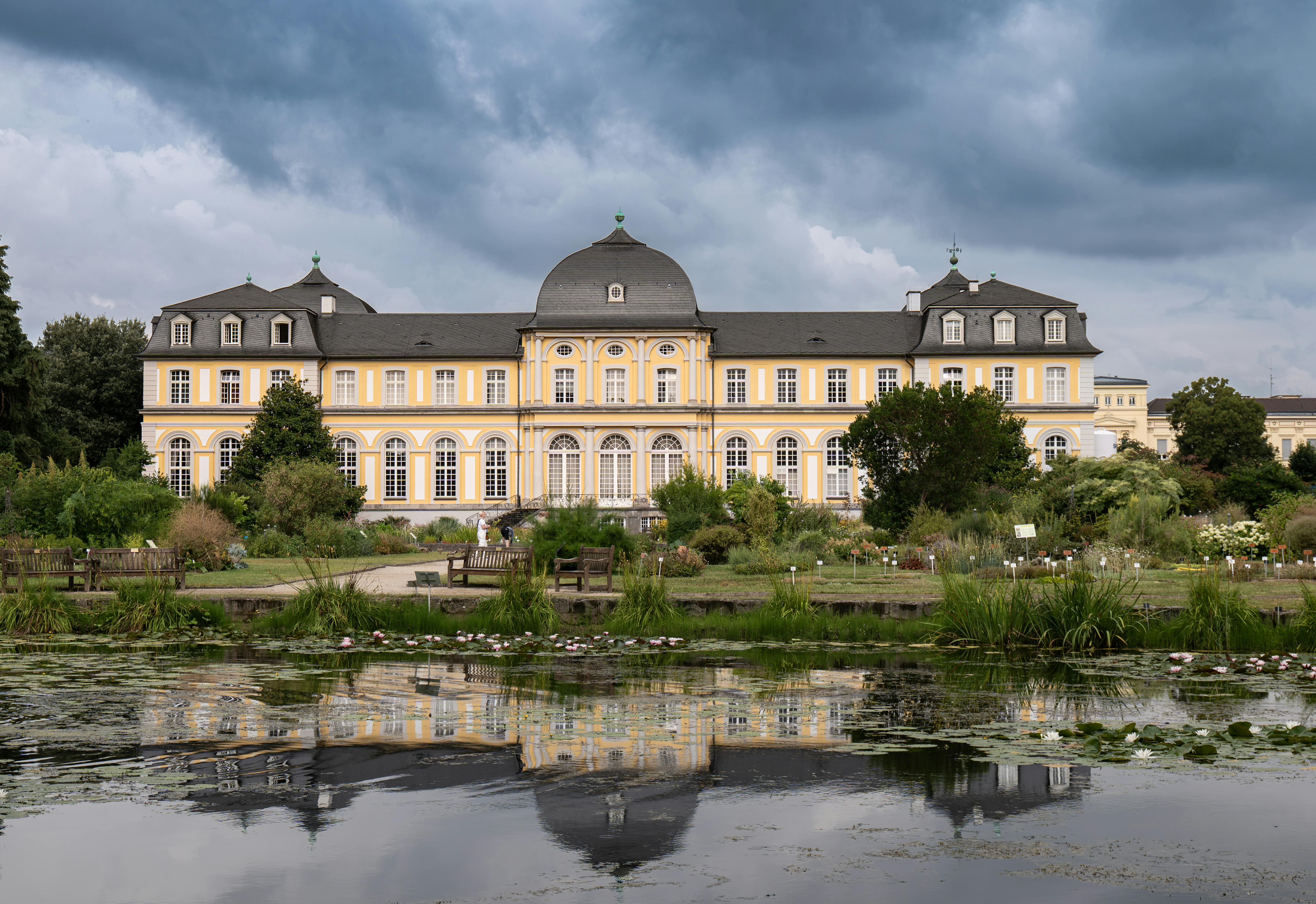 Stunning view of Poppelsdorf Palace in Bonn, Germany, reflected in a botanical garden pond.