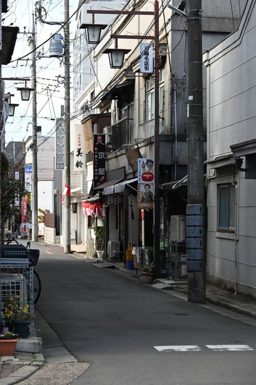 Free Charming Japanese alley with traditional shops on a clear day, perfect for travel inspiration. Stock Photo