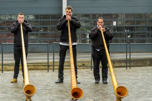 Free Three Alphorn players performing outdoors in Lucerne, Switzerland. Stock Photo